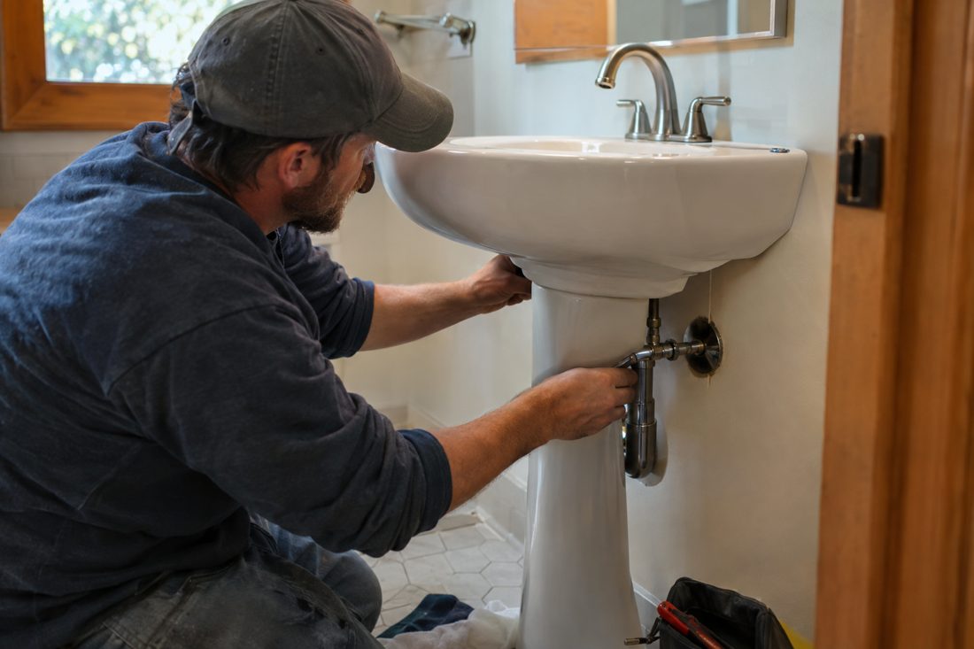 A new pedestal sink being installed in a small bathroom at a mid-century ranch house in the Kettering area of Dayton, Ohio in Dayton, OH